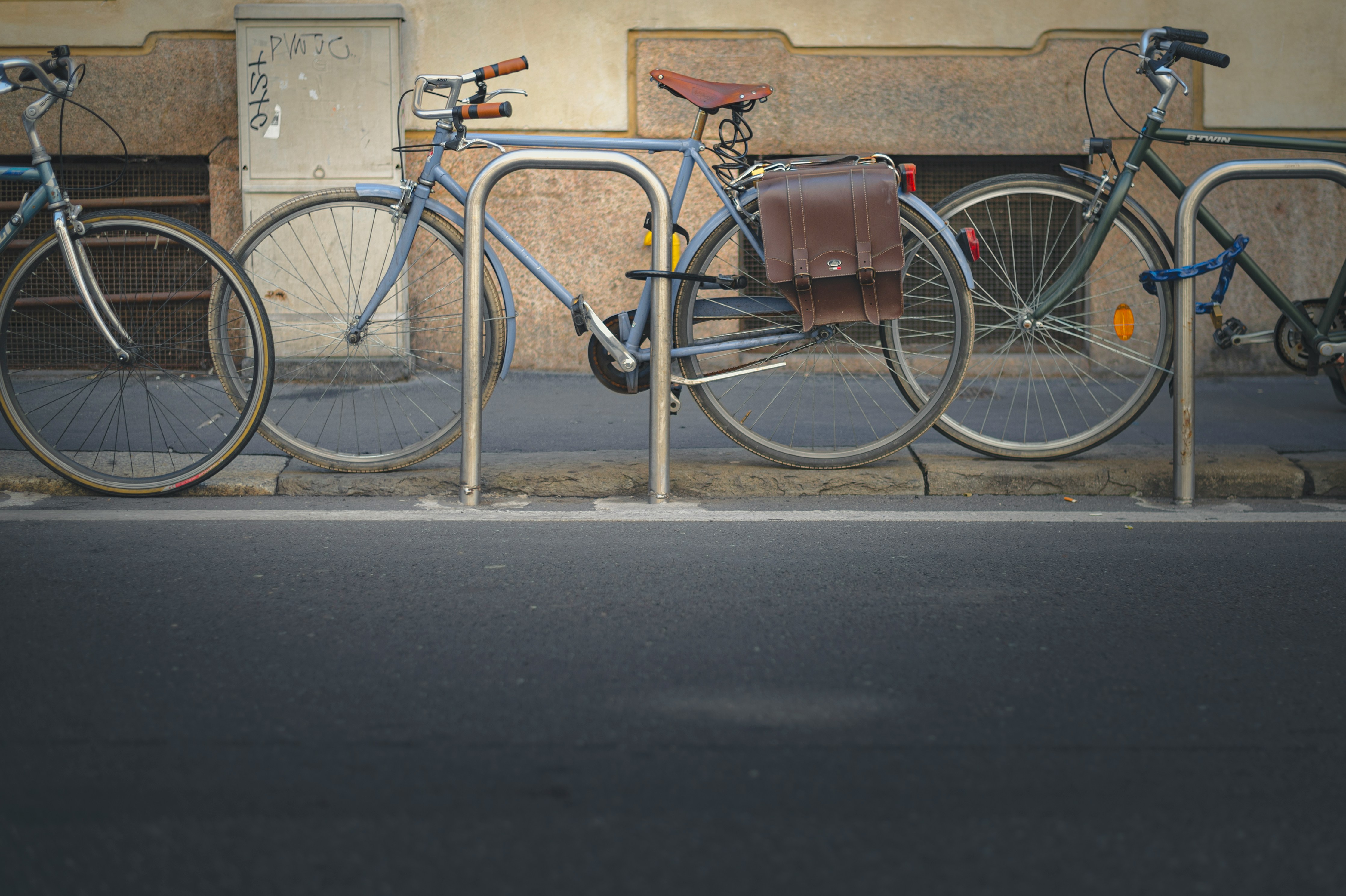 Three bikes locked up on the road.