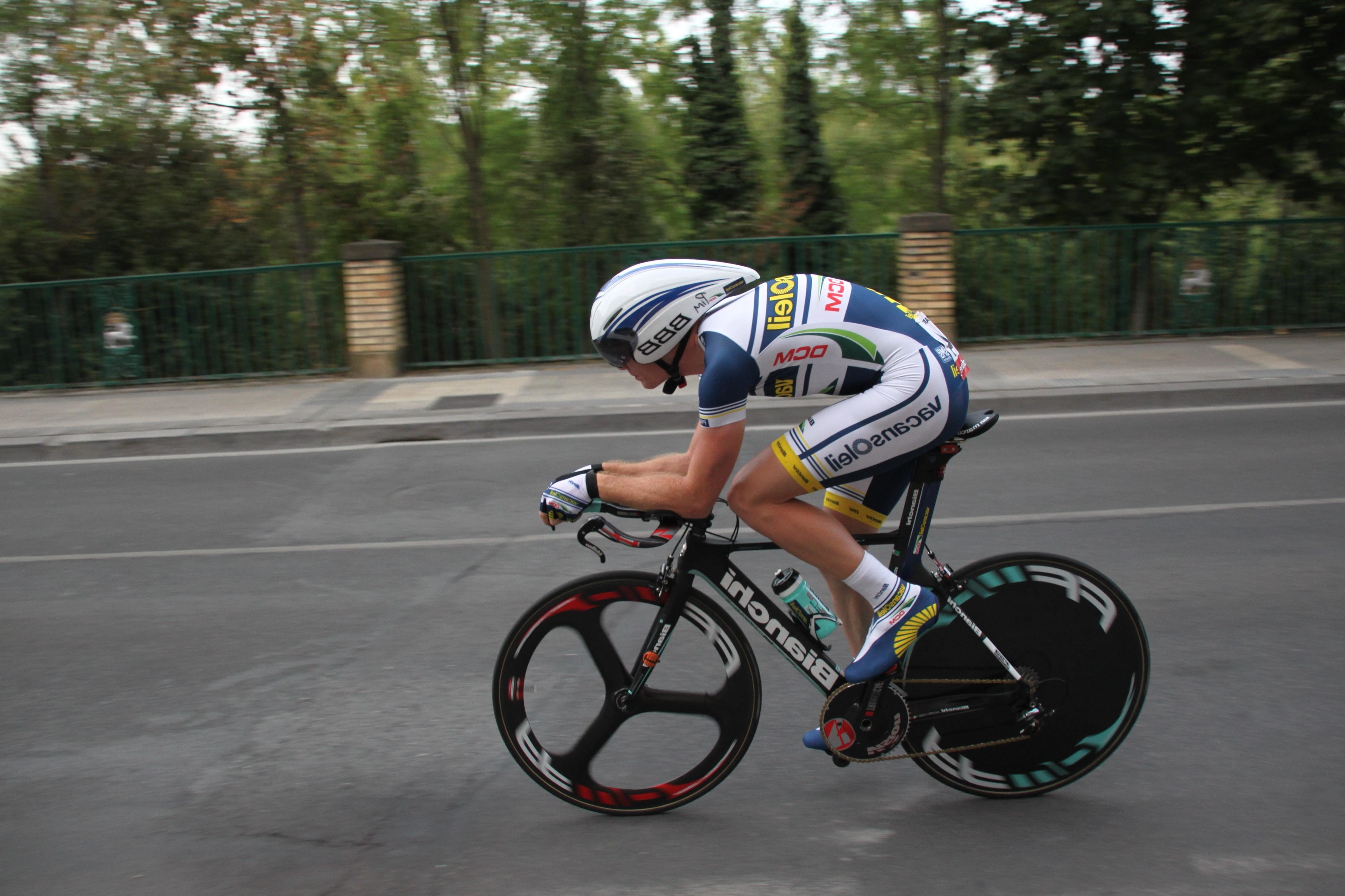 Cyclist racing on a road.